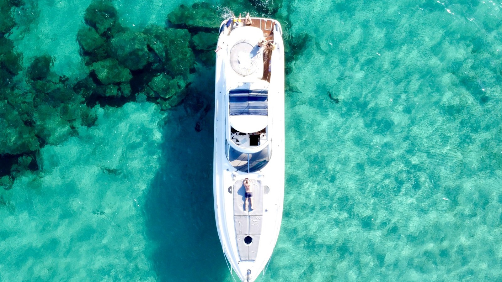 Aerial view of a superyacht on turquoise water